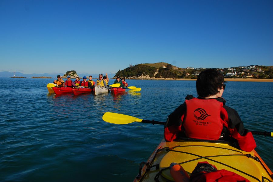 Sea-kayak between golden-sand coves